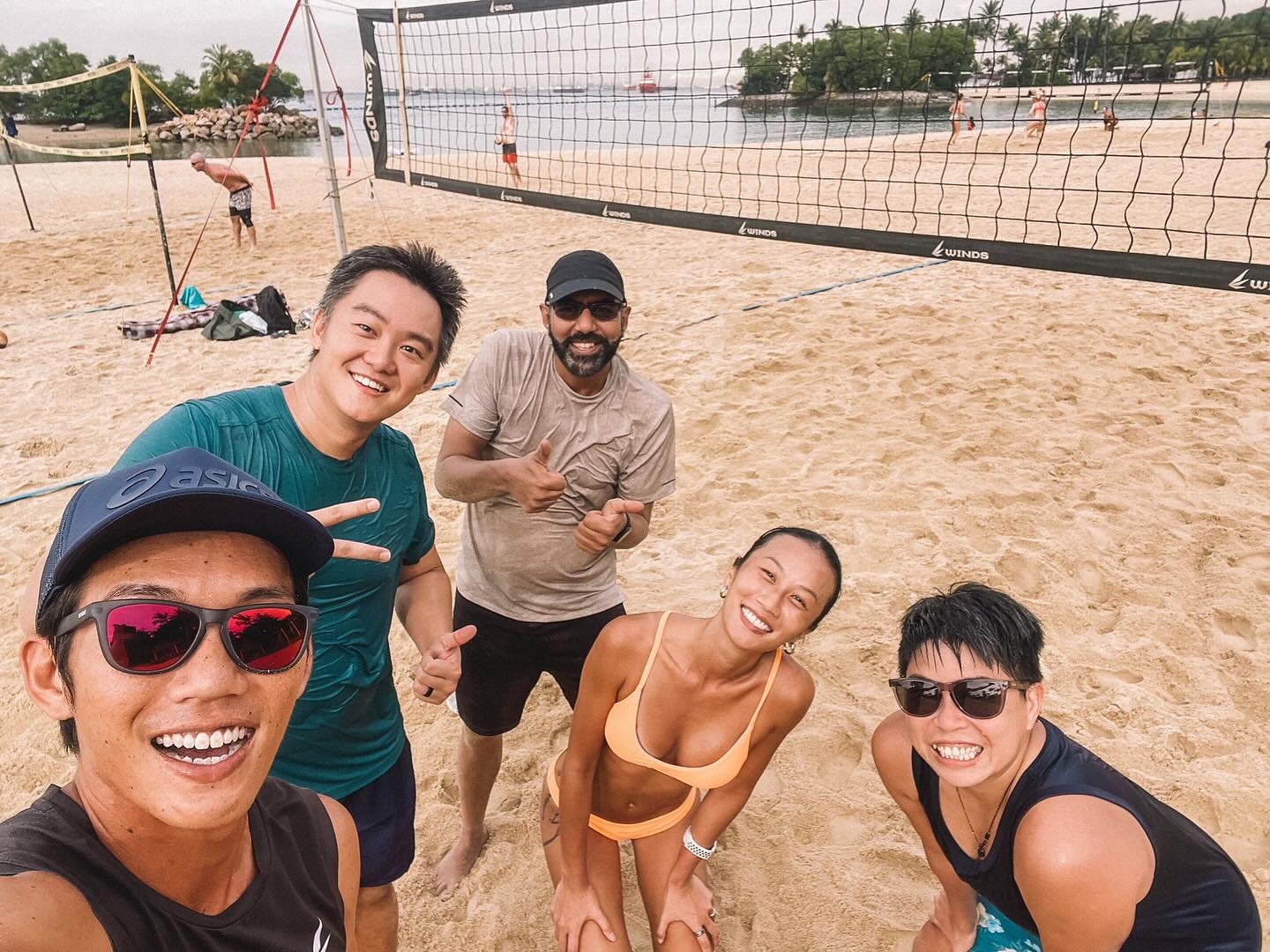 Friends enjoying beach volleyball together